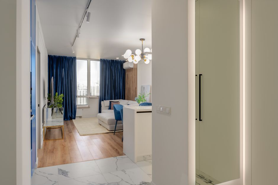 Contemporary living room with blue curtains and chic decor, perfect for cozy home vibes.